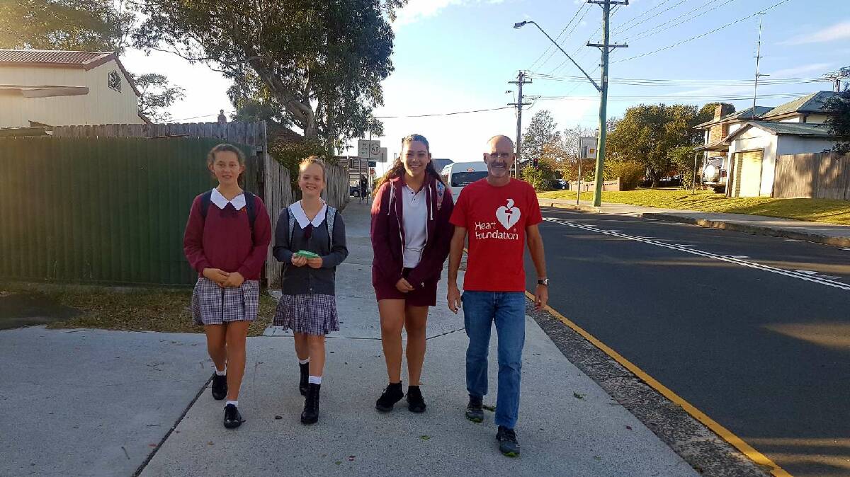 SAFE WALKING: Dapto High School students Kaylen Elliott, Carla Paloff and Olivia Kedere with Heart Foundation Illawarra's Andy Mark taking part in National Walk Safely to School Day. 