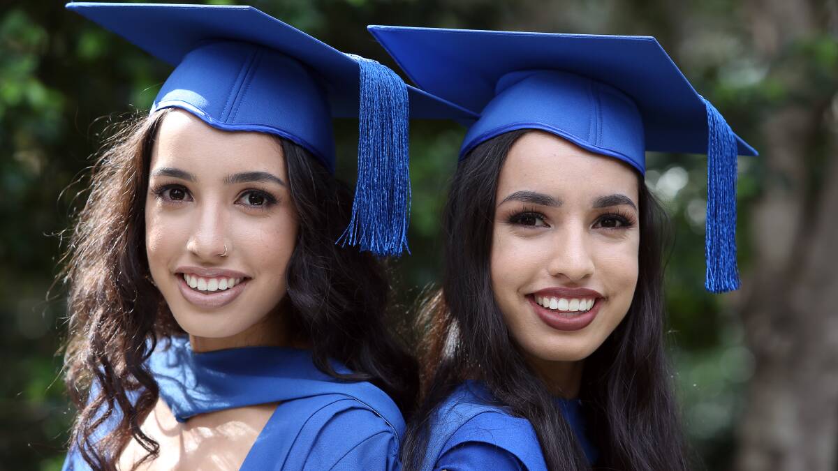 TWINS: Kathleen McKinnon and Marianne McKinnon graduated with a Bachelor of Nursing degree from the University of Wollongong on Thursday. Picture: Robert Peet. 