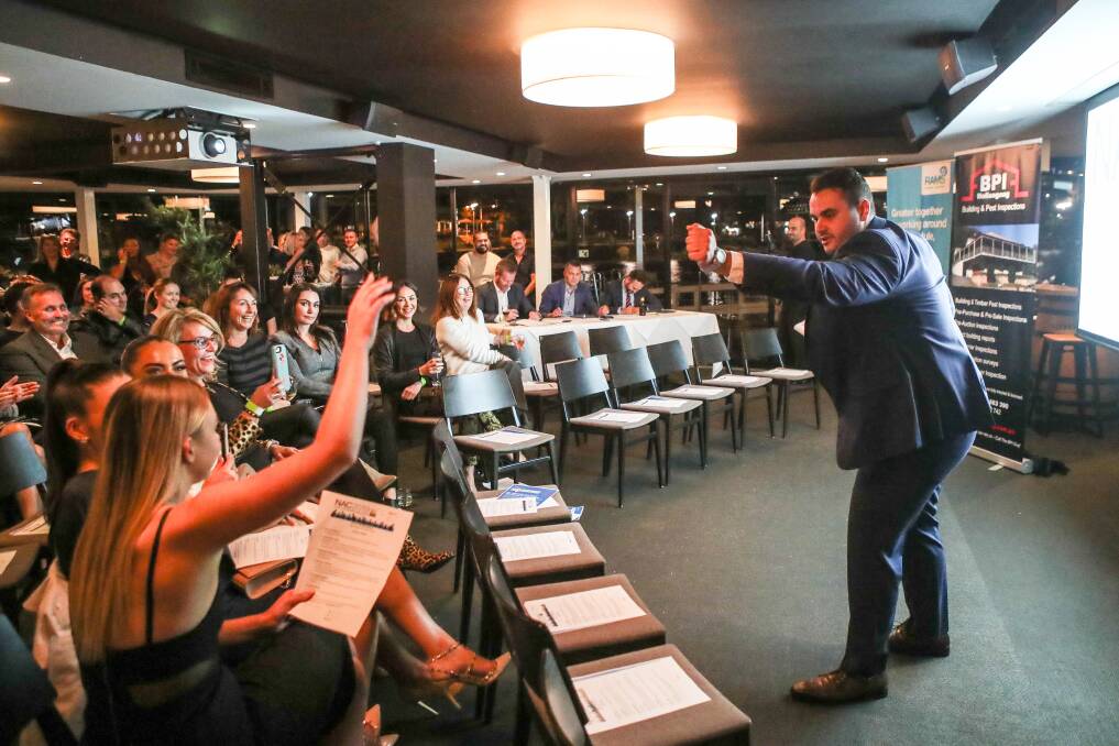 FUNDRAISER: Kimon Kallinikos in action at the Harbourfront Seafood Restaurant on Thursday night, during the Wollongong heat of the Novice Auctioneers Competition. Picture: Adam McLean