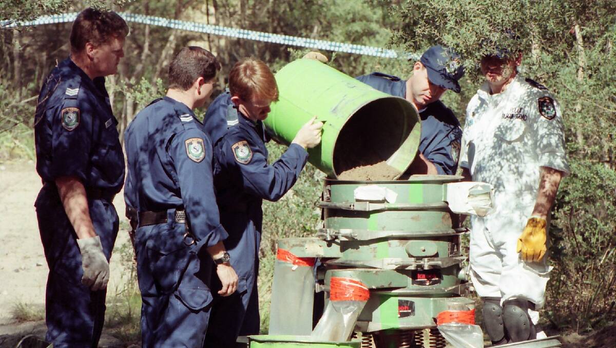 Police inspect the crime scene in September 1997 where Jodie Fesus' body was found.
