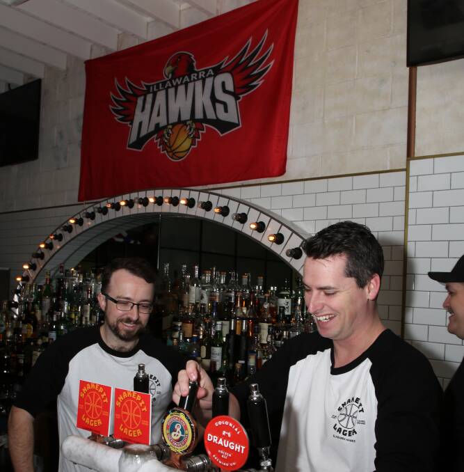 Local support: Five Barrel Brewing's Phil O'Shea and His Boy Elroy owner Lachlan Stevens pour a new Snakepit Lager ahead of the basketball season in support of the Illawarra Hawks. Picture: Greg Ellis. 