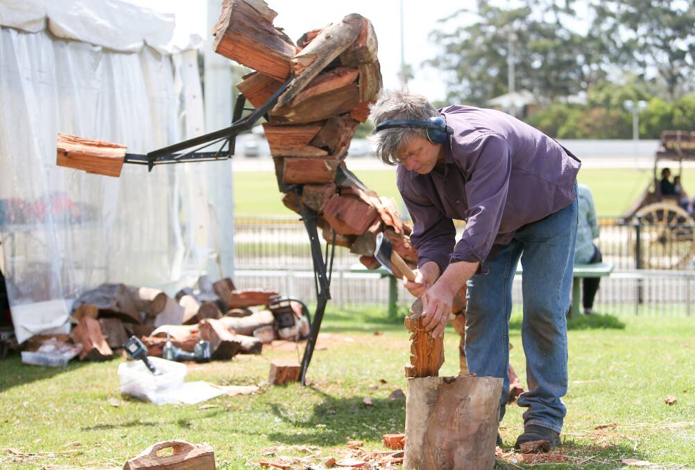 Timber: Marcus Tatton makes a sculpture of a wood-chopper at the Illawarra Festival of Wood that attracted 8000 people to Bulli Showground over the weekend. Picture: Adam McLean.

