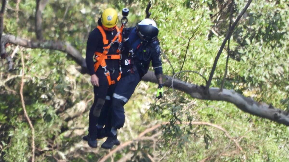 Rescuers at Belmore Falls on Monday, April 8 as they search for a woman who went missing the previous day. Picture by Darren Malone