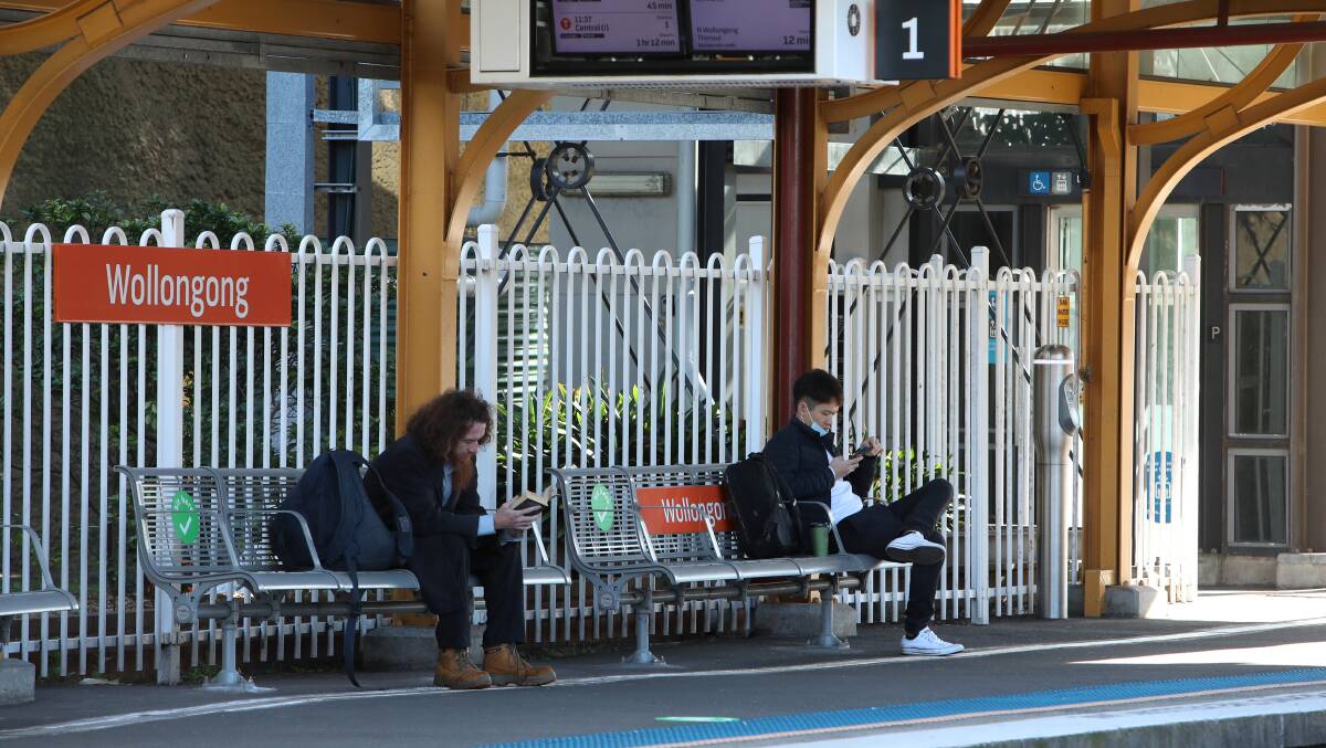 People sitting at Wollongong Station. Picture by Sylvia Liber
