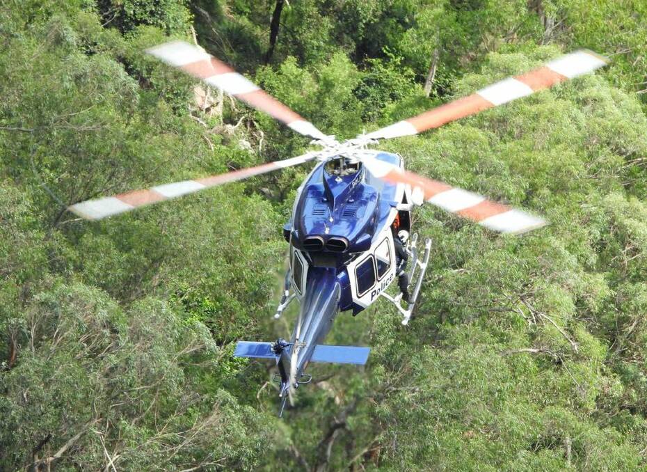 Rescuers at Belmore Falls on Monday, April 8 as they search for a woman who went missing the previous day. Pictures by Darren Malone